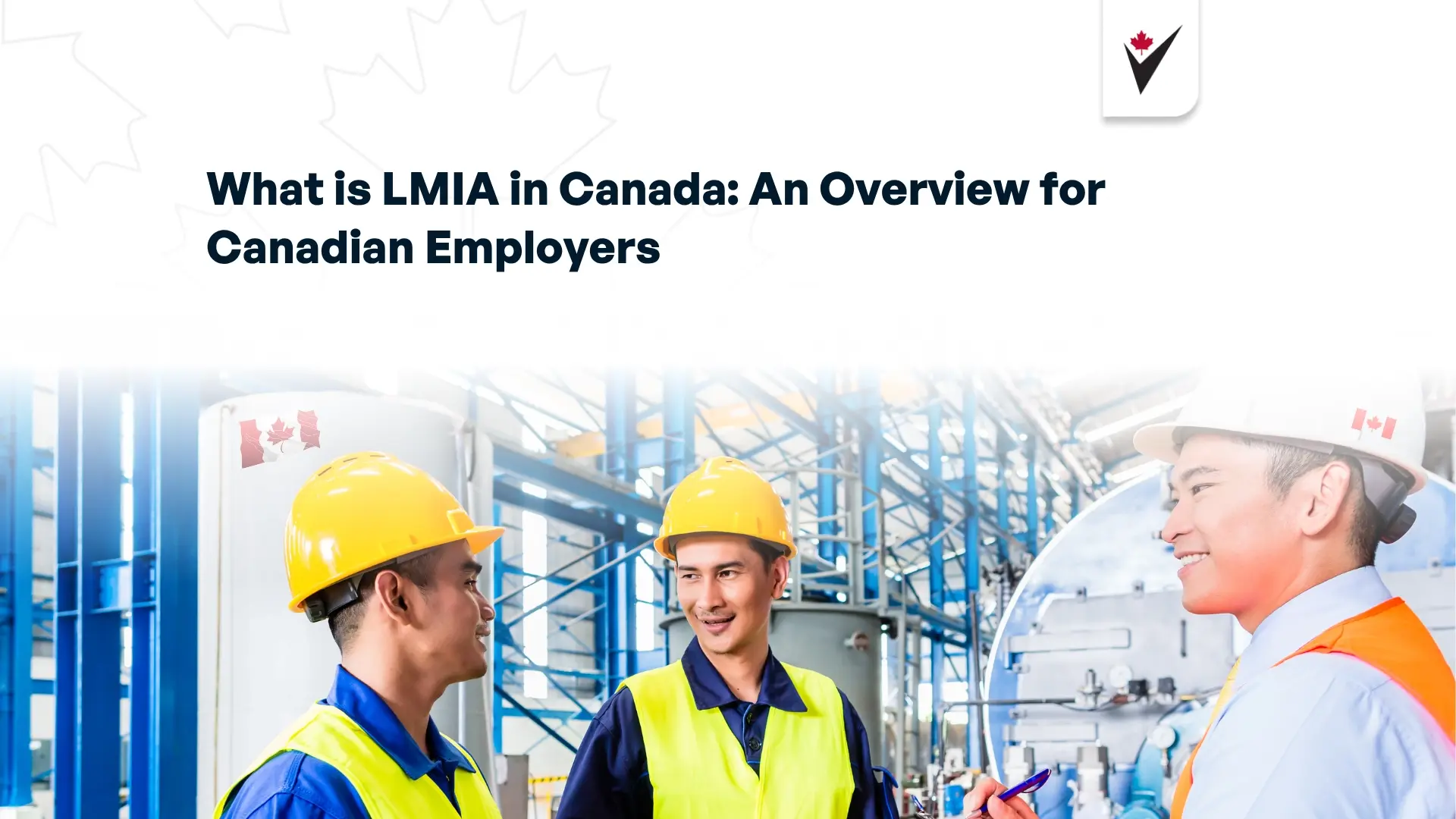 Workers wearing hard hats, chatting to each other while working in a Canadian factory.